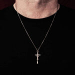 Man wearing silver crucifix pendant